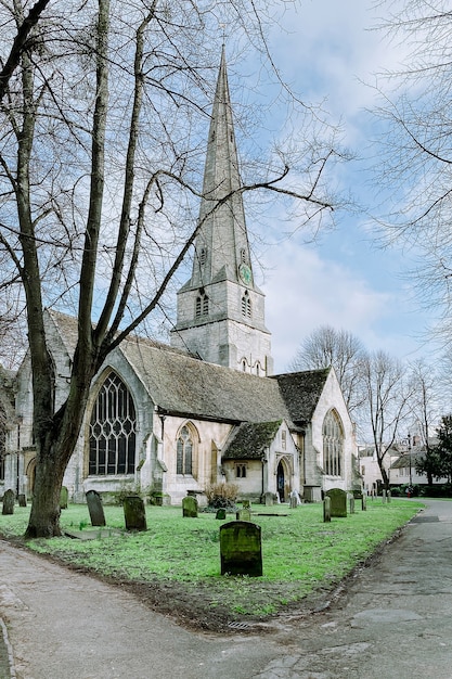 St. Mary's church on a green lawn surrounded by graves and trees