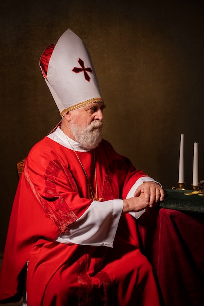 Free Photo st nicholas sitting on chair side view