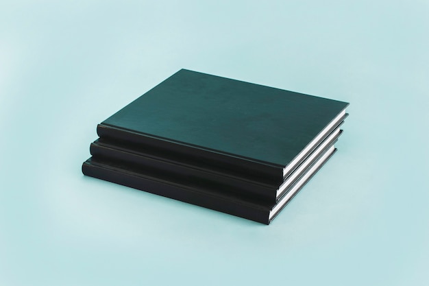 Free photo stack of black notebooks