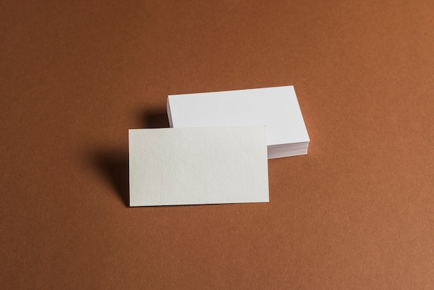 Free photo stack of blank business cards on brown background