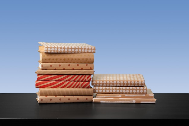 Stack of books on black wooden table