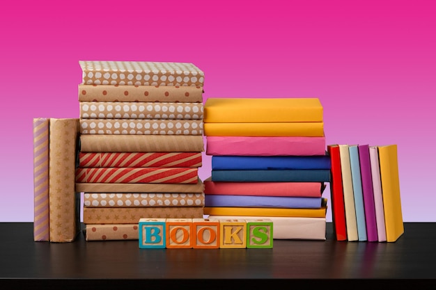 Stack of books on black wooden table