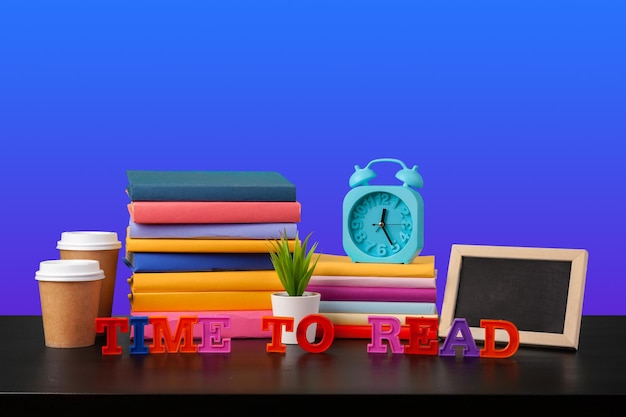 Stack of books on black wooden table