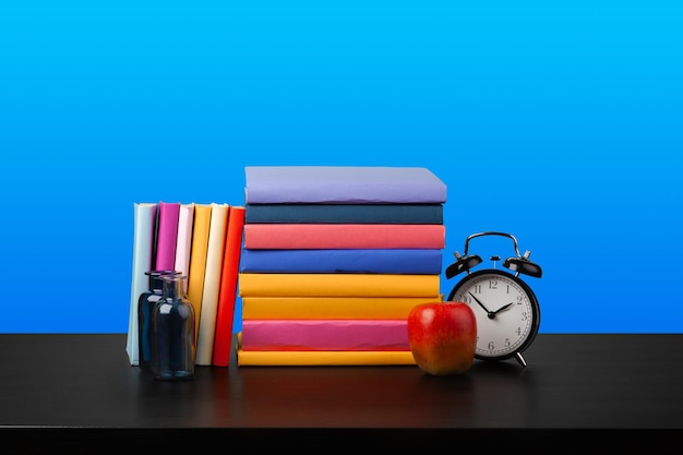 Free photo stack of books on black wooden table