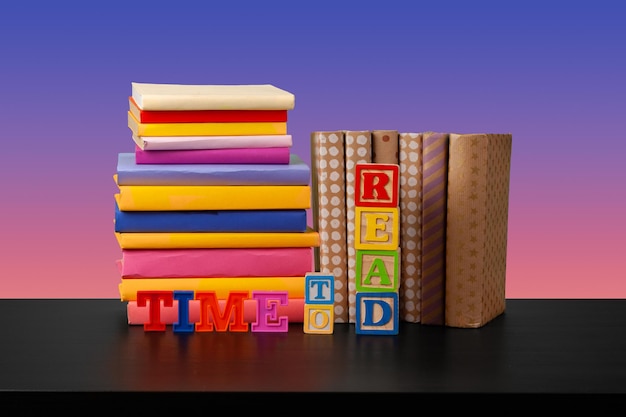 Stack of books on black wooden table