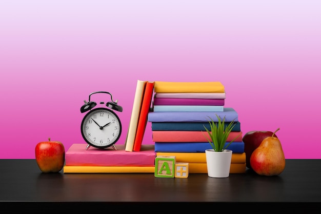 Free photo stack of books on black wooden table