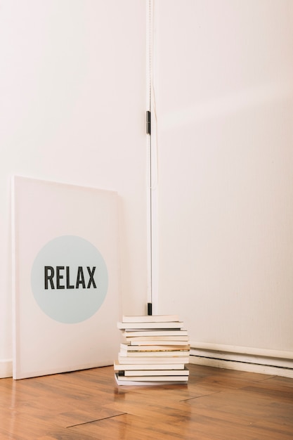 Free Photo stack of books lying near inspirational poster