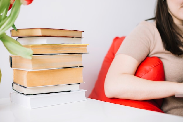 Free Photo stack of books near crop woman