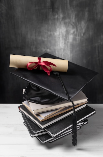 Stack of books with gradution diploma