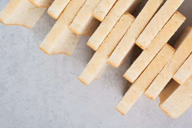 Stack of bread slices on stone surface