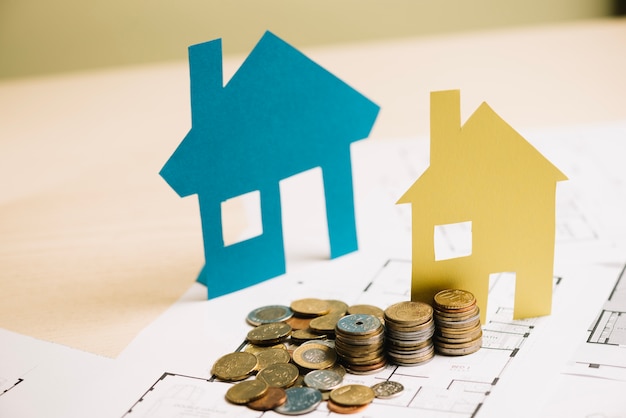 Stack of coins and paper houses