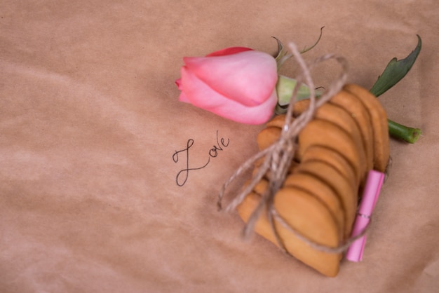 Stack of cookies in heart shape with rose 