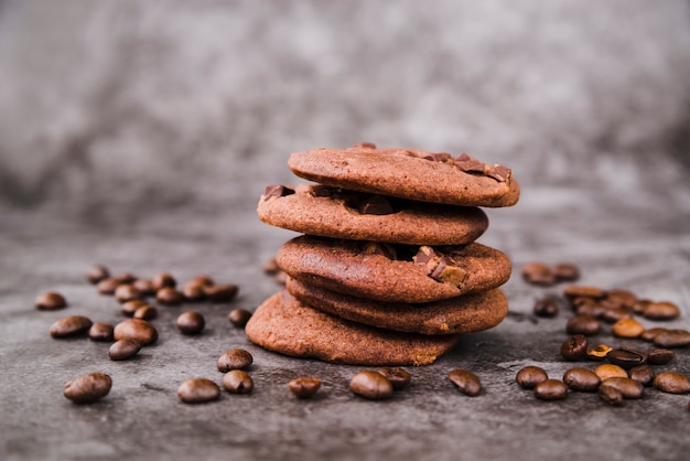 Free Photo stack of cookies and roasted coffee beans on grunge backdrop