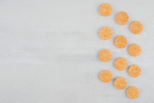 Stack of cookies with cream on white background.