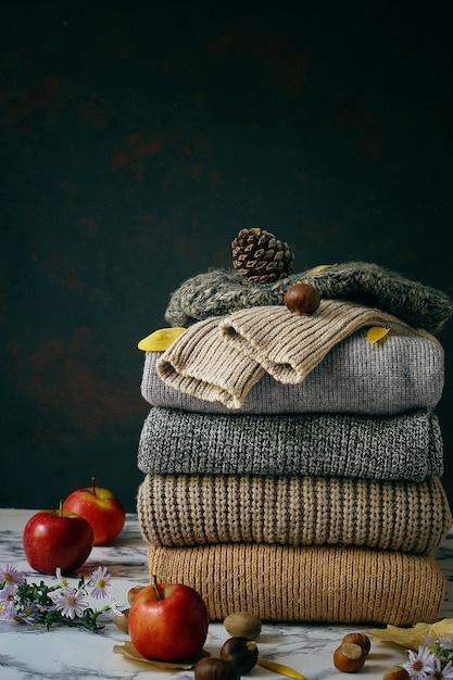 Stack of cozy knitted sweaters. Autumn-winter concept, Knitted wool sweaters. Pile of knitted winter clothes, sweaters, knitwear