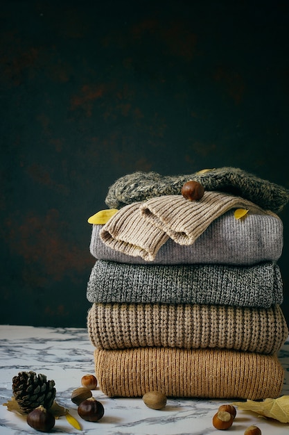 Stack of cozy knitted sweaters. Autumn-winter concept, Knitted wool sweaters. Pile of knitted winter clothes, sweaters, knitwear