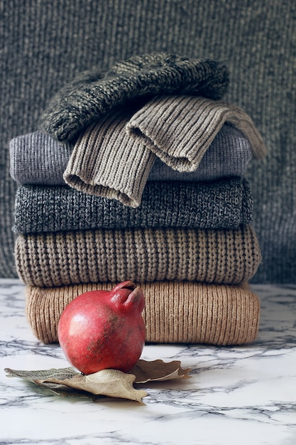 Free Photo stack of cozy knitted sweaters. autumn-winter concept, knitted wool sweaters. pile of knitted winter clothes, sweaters, knitwear