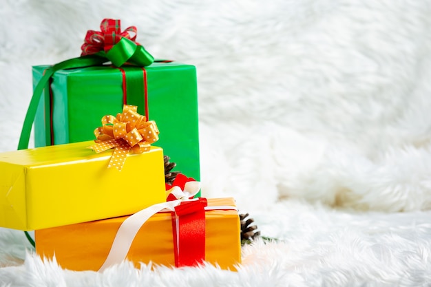 Stack of gift boxes on white fur fabric