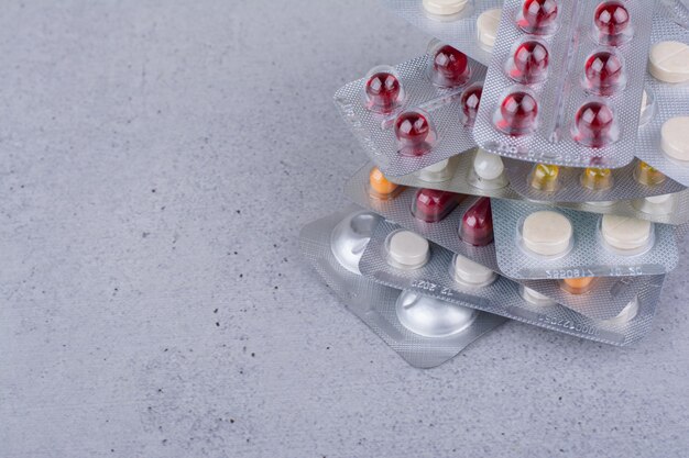 Stack of medical drugs on marble background. High quality photo