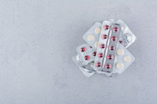 Stack of medical drugs on marble background. 