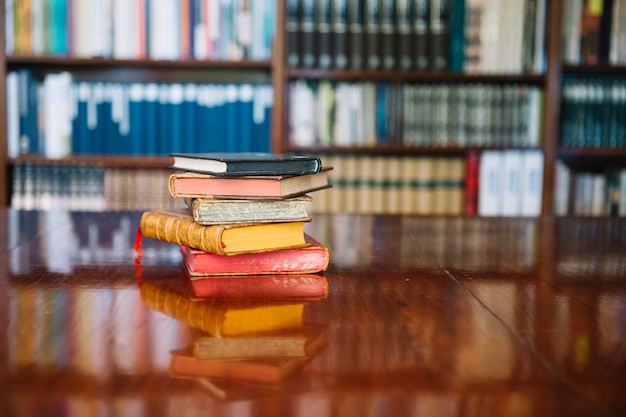 Free photo stack of old books on library table