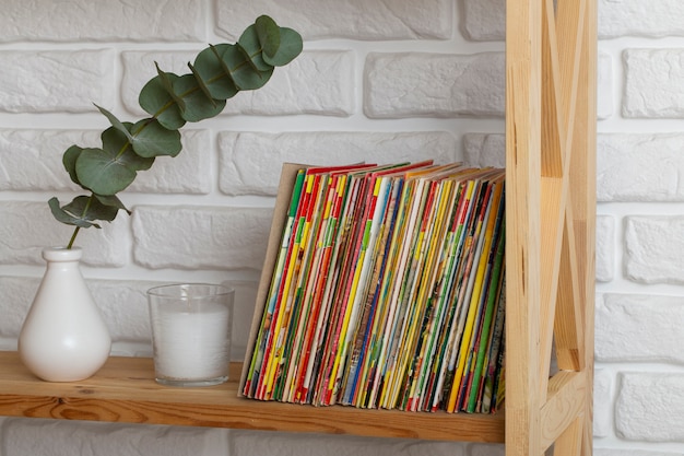 Free photo stack of old coming book strips on wooden shelf