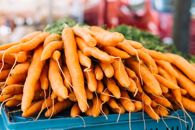 Stack of an orange harvested carrots in the farm market