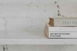 Free photo stack of psychology books on a white marble shelf