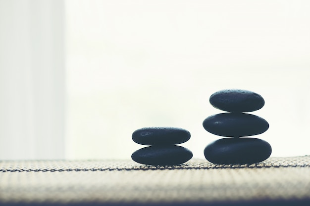 Free photo stack of spa hot stones isolated on white background