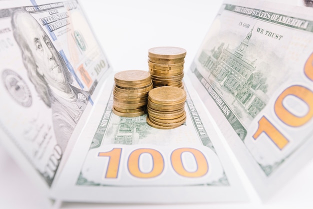 Stacked coins and american banknotes