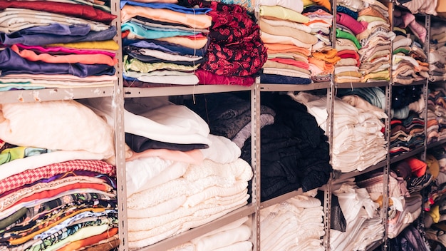 Free Photo stacked of colorful fabrics in the shelf