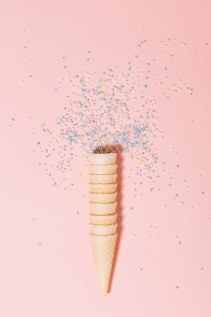 Stacked of waffles with sprinkle balls on pink background