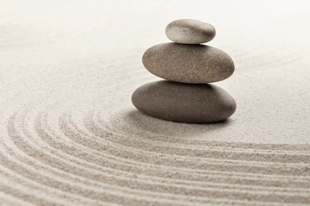 Free photo stacked zen stones sand background art of balance concept