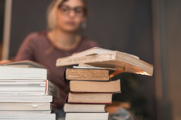 Free photo stacks of books near woman