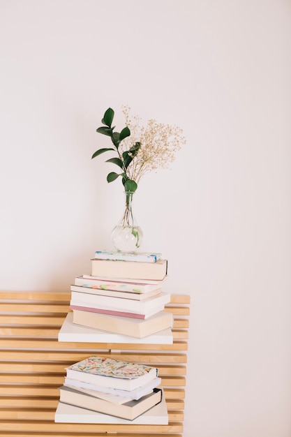 Stacks of books and notebooks with bouquet