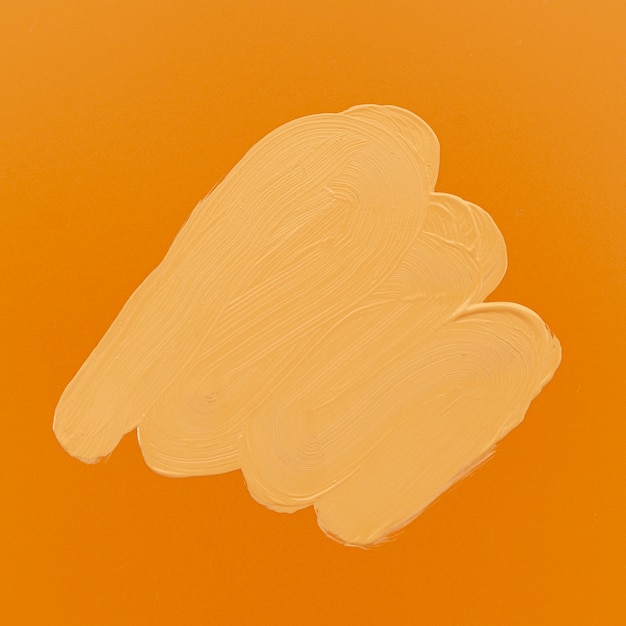 Free photo stain of foundation on orange background