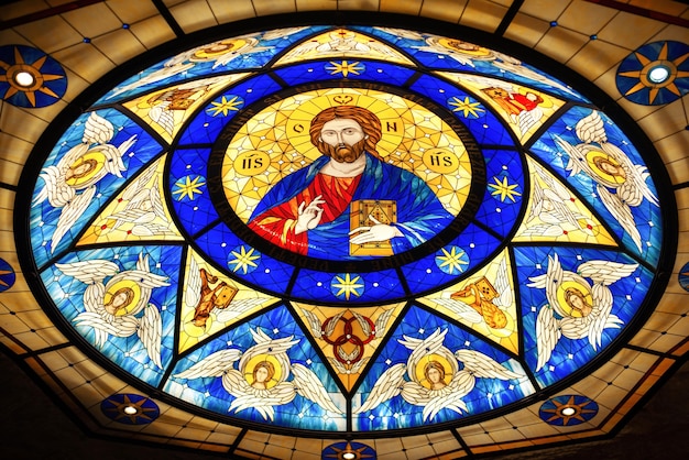 Free photo stained glass roof in a church with the image of jesus