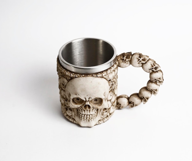 Free photo stainless steel skull beer mug on white background