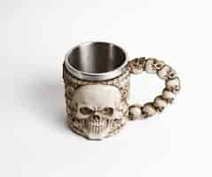 Free photo stainless steel skull beer mug on white background