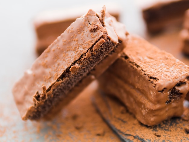 Staked pieces of brownies with cocoa powder