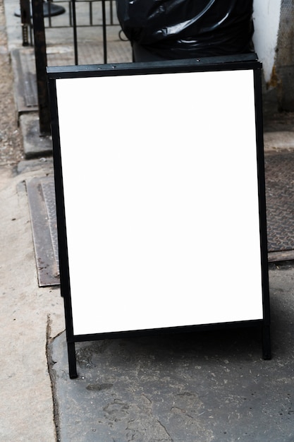 Free photo standing billboard template in front of shop