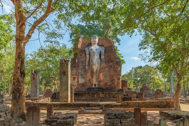 Free Photo standing buddha statue at wat phra si ariyabot temple in kamphaeng phet historical park unesco world heritage site