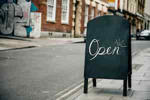 Free photo standing frame of an open sign for business