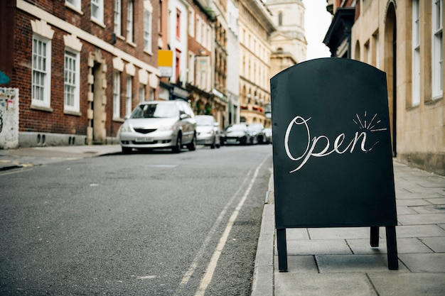 Free photo standing frame of an open sign for business