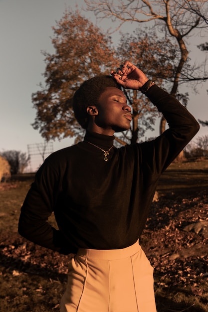 Standing man with eyes close during daytime