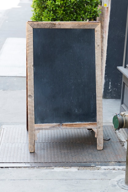 Free photo standing restaurant chalkboard sign template