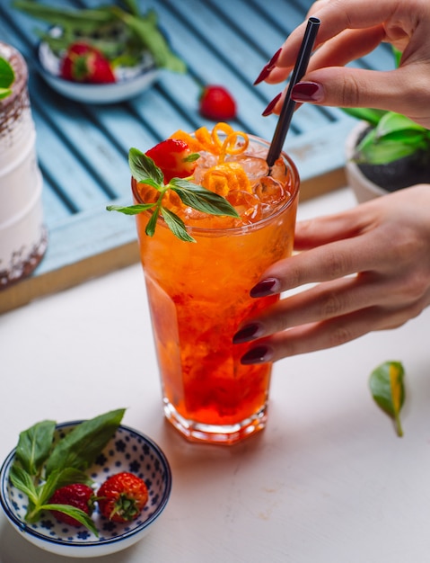 starberry and orange juice with ice, strawberry and orange particles