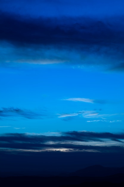 Starry night with clouds in blue shades