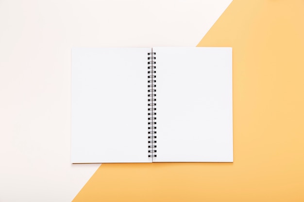 Free photo stationery elements with empty opened notepad