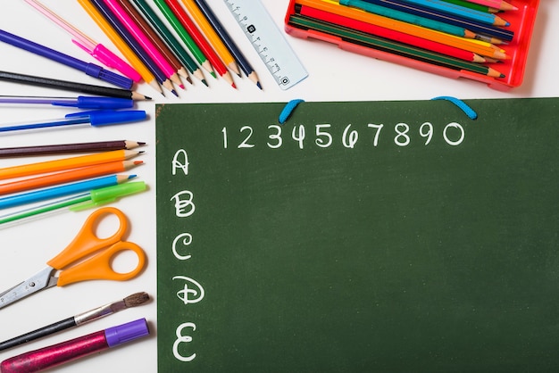 Stationery lying around chalkboard